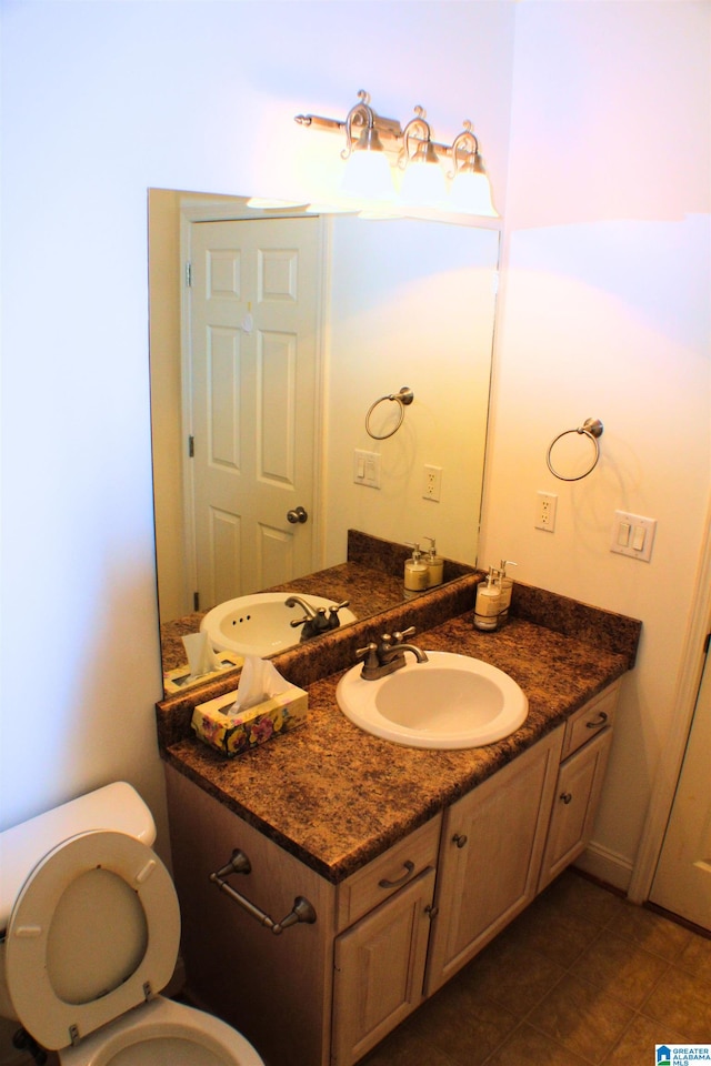 bathroom featuring vanity, toilet, and tile patterned floors