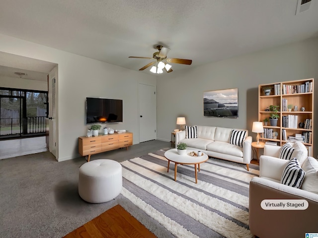 living room with baseboards, visible vents, and a ceiling fan