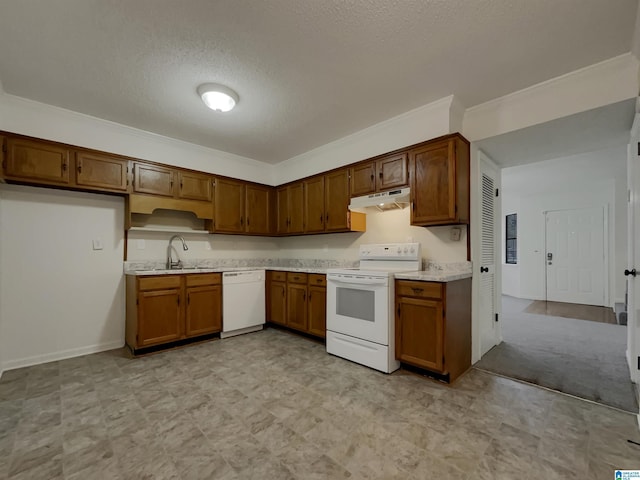 kitchen with light countertops, brown cabinetry, a sink, white appliances, and under cabinet range hood