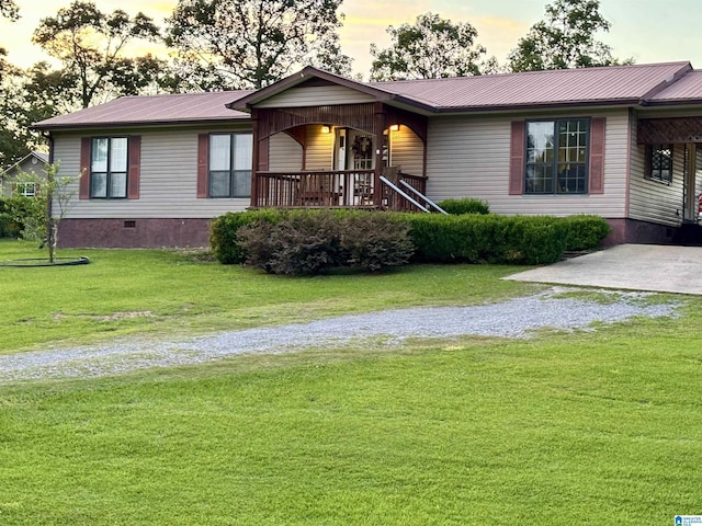 single story home with driveway, a lawn, metal roof, crawl space, and covered porch