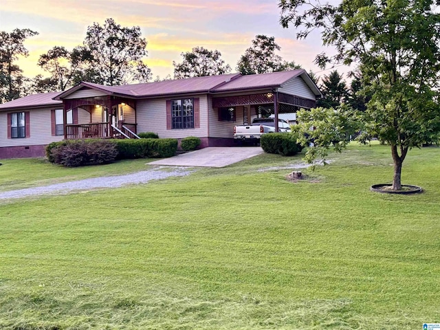 single story home featuring driveway, a front lawn, metal roof, and an attached carport