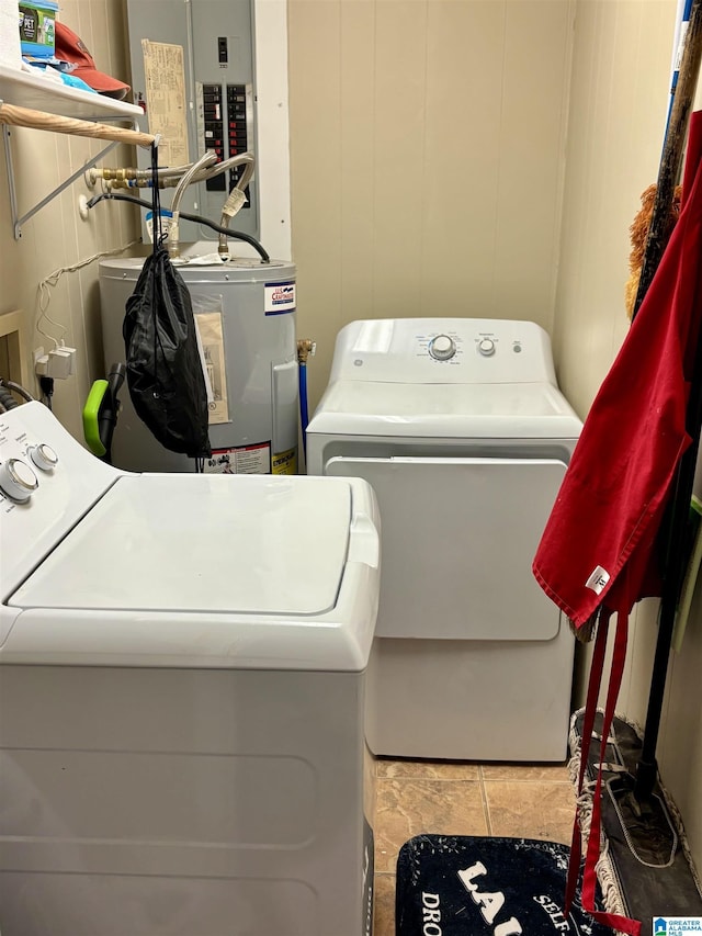 laundry area featuring electric panel, laundry area, water heater, and separate washer and dryer