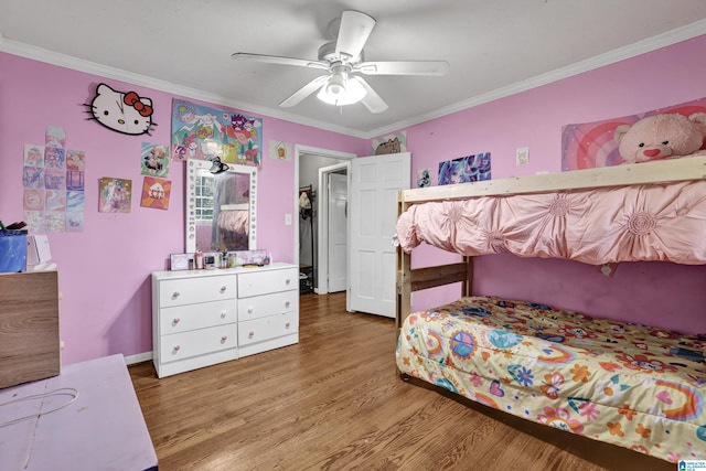 bedroom featuring ornamental molding, wood finished floors, and a ceiling fan