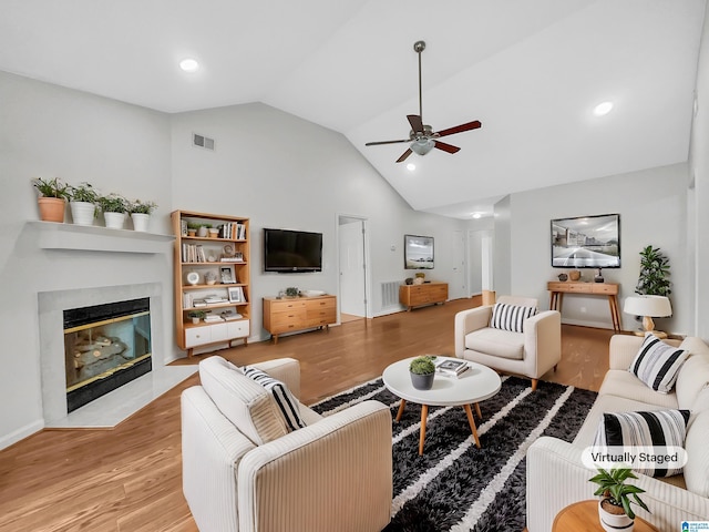 living room with recessed lighting, a fireplace with flush hearth, visible vents, a ceiling fan, and light wood-type flooring