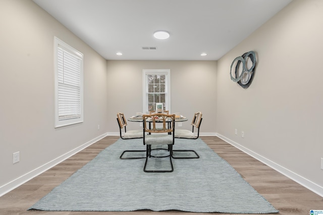 dining room with baseboards, visible vents, wood finished floors, and recessed lighting