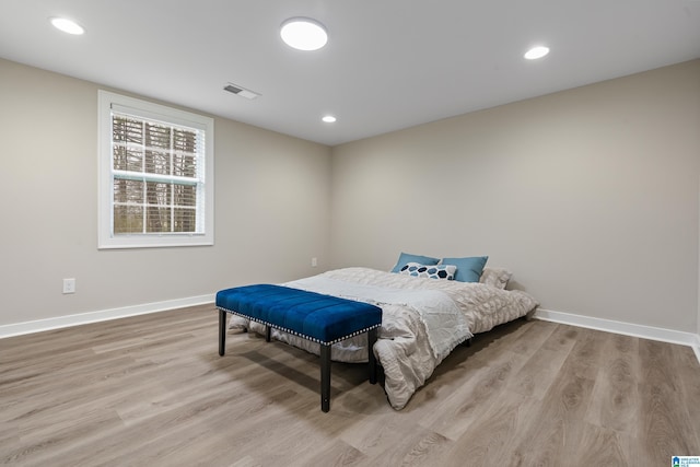 bedroom with recessed lighting, wood finished floors, visible vents, and baseboards