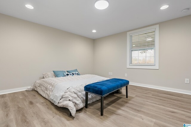 bedroom with light wood-type flooring, baseboards, and recessed lighting