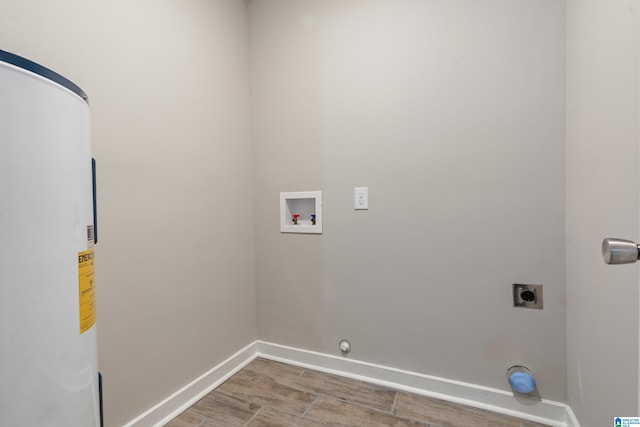 clothes washing area featuring electric water heater, hookup for an electric dryer, laundry area, washer hookup, and baseboards