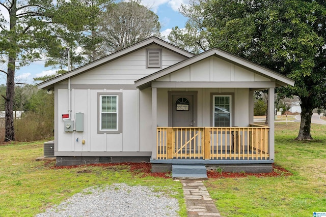 bungalow-style home featuring crawl space, a front lawn, a porch, and board and batten siding