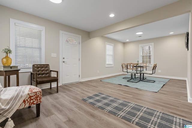 entryway with light wood-type flooring, baseboards, and recessed lighting