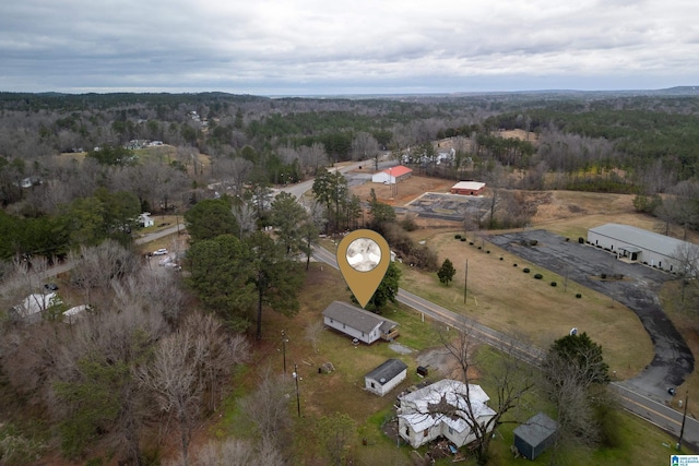 aerial view featuring a forest view and a rural view