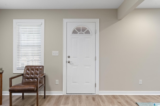 entrance foyer with light wood-style flooring and baseboards