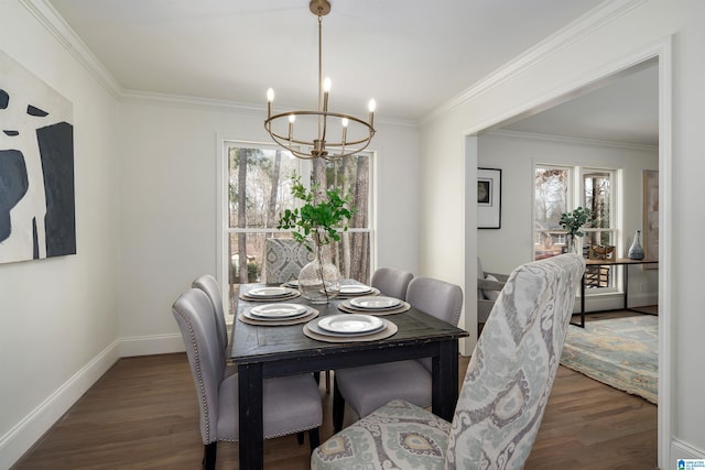 dining room featuring baseboards, ornamental molding, wood finished floors, and a notable chandelier