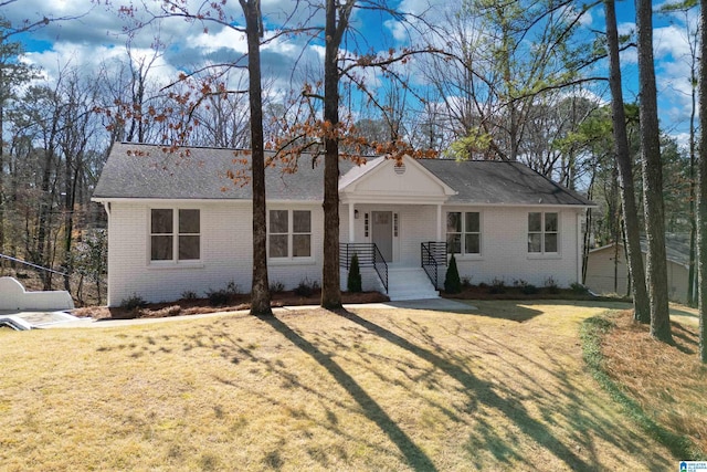 single story home with a front lawn and brick siding