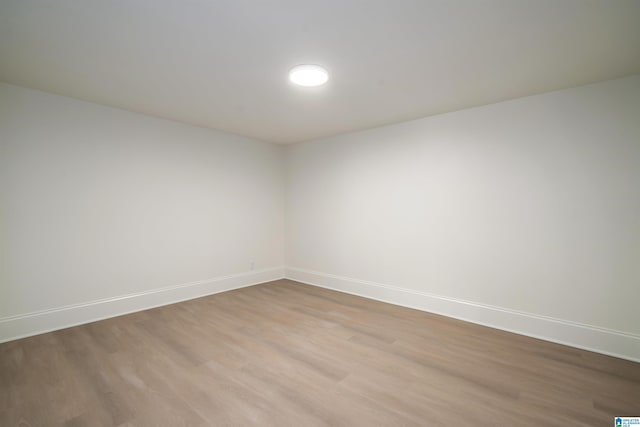 spare room with light wood-type flooring and baseboards