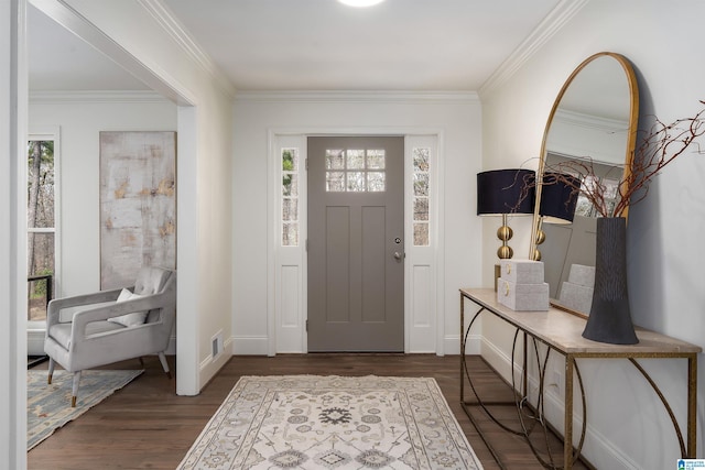 foyer entrance featuring crown molding, visible vents, and dark wood-type flooring