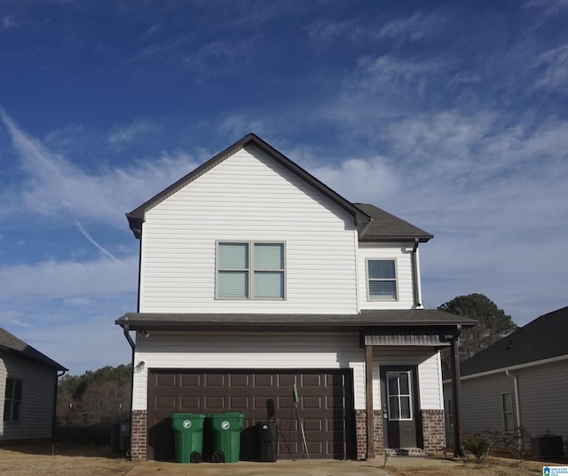 view of front facade featuring a garage, cooling unit, brick siding, and driveway