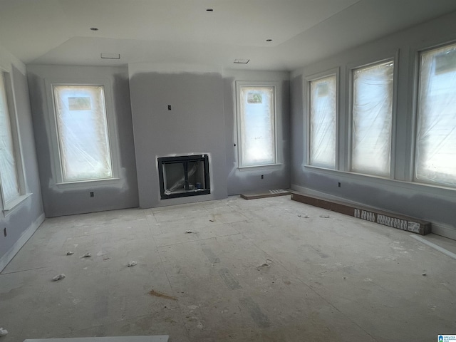 unfurnished living room with a healthy amount of sunlight, a fireplace, and visible vents