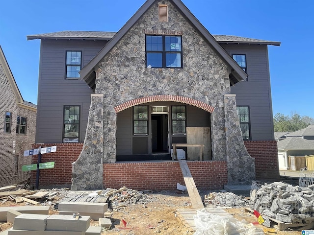 view of front facade featuring stone siding and brick siding