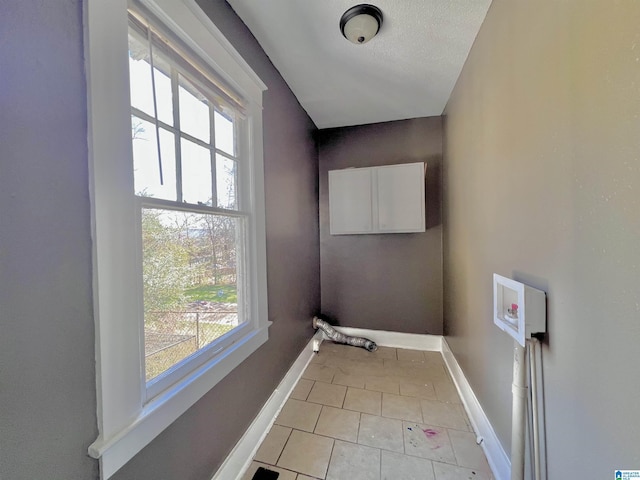 laundry room with light tile patterned floors, laundry area, hookup for a washing machine, and baseboards