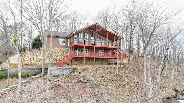 back of property with stairs and a deck