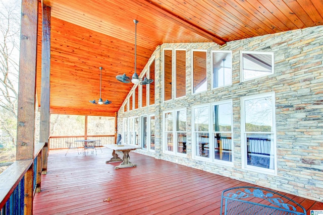 unfurnished sunroom featuring wood ceiling and lofted ceiling with beams