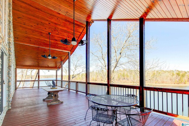 unfurnished sunroom featuring vaulted ceiling, wooden ceiling, a water view, and ceiling fan