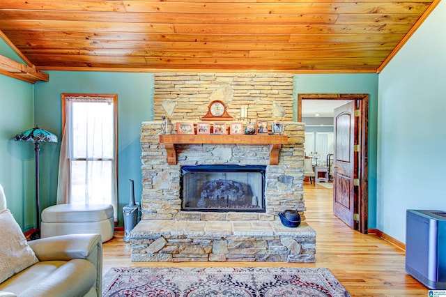 living room featuring wood ceiling, a fireplace, vaulted ceiling, and light wood-style flooring