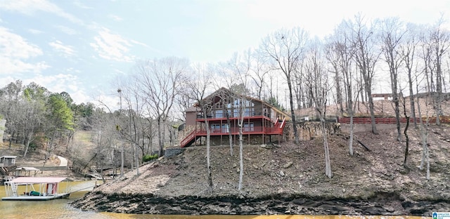 back of house featuring stairway and a wooden deck