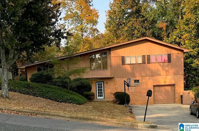 view of front of house featuring concrete driveway and an attached garage