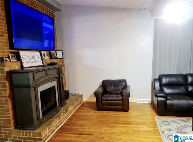 1525 NW Ridge St, Cullman, AL 35055 - living room featuring visible vents, baseboards, wood finished floors, and a fireplace