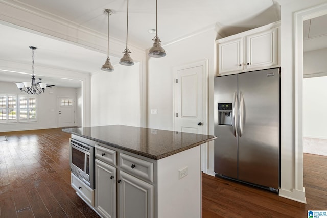 kitchen featuring pendant lighting, dark wood-style flooring, white cabinetry, appliances with stainless steel finishes, and crown molding