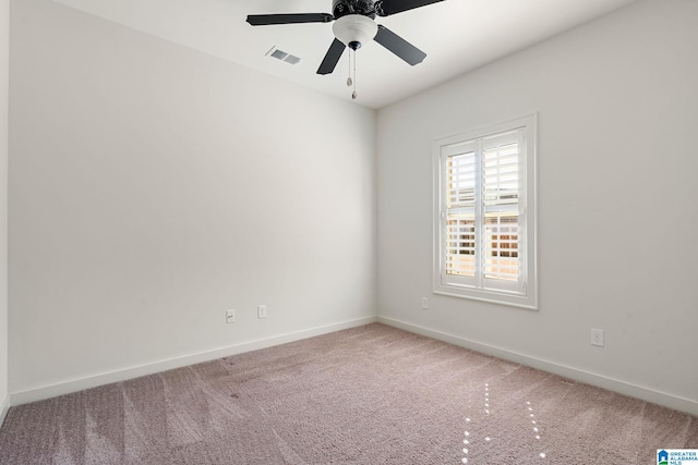 empty room with baseboards, visible vents, ceiling fan, and carpet flooring