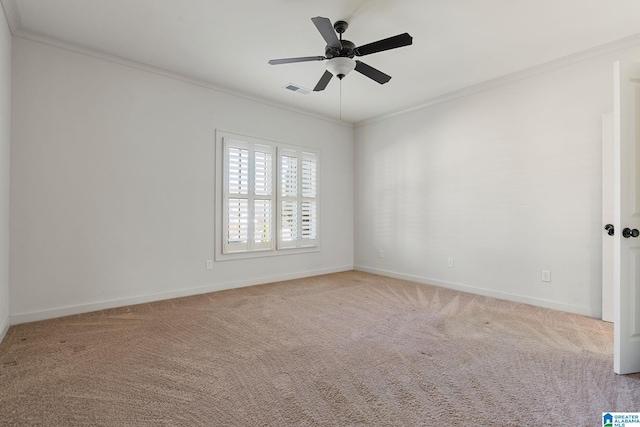 unfurnished room with carpet floors, baseboards, visible vents, and crown molding