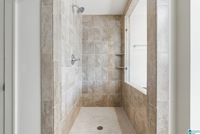 bathroom with a tile shower