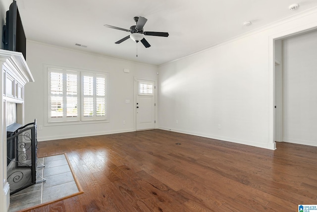 unfurnished living room featuring hardwood / wood-style floors, a ceiling fan, visible vents, and crown molding