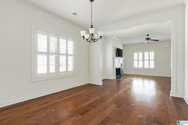 unfurnished living room with baseboards, visible vents, dark wood finished floors, a fireplace with flush hearth, and crown molding