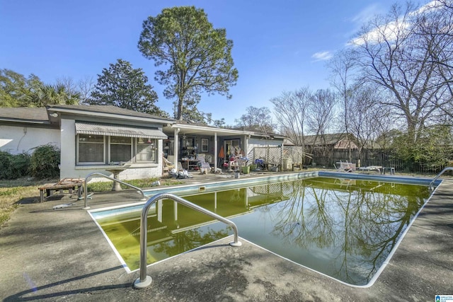 view of pool featuring fence, a fenced in pool, and a patio