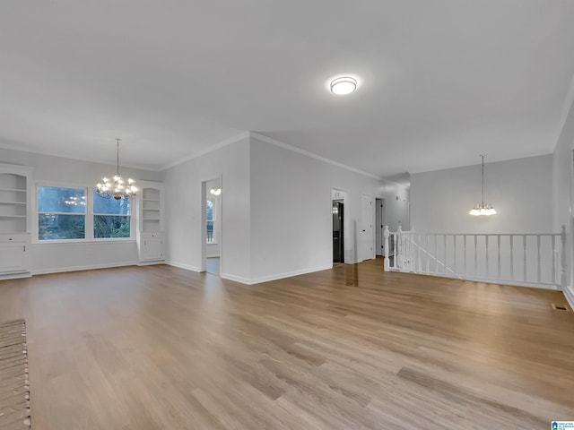 unfurnished living room featuring light wood-style floors, baseboards, built in shelves, and a chandelier