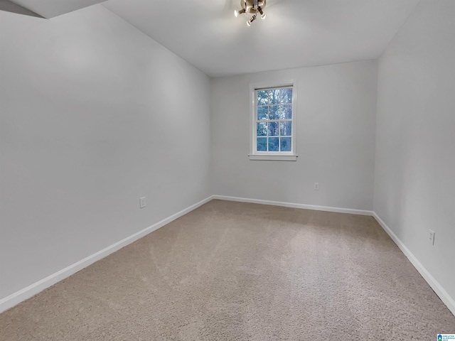 spare room with carpet floors and baseboards