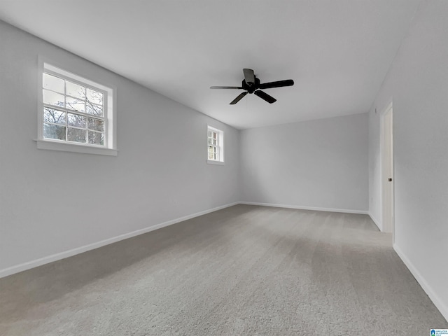 spare room featuring carpet floors, baseboards, and a ceiling fan