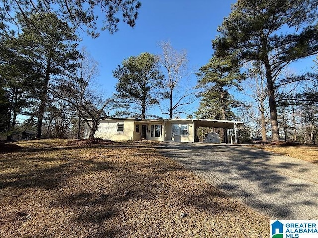 single story home with driveway and a carport