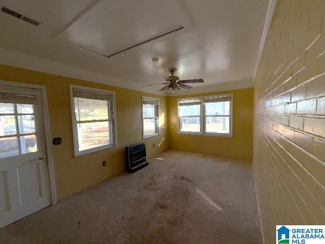 unfurnished room featuring heating unit, ceiling fan, visible vents, and light colored carpet