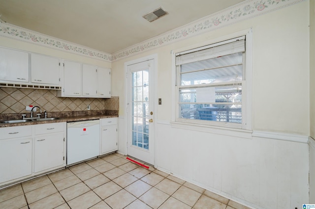 kitchen with a sink, visible vents, white cabinetry, dishwasher, and dark countertops