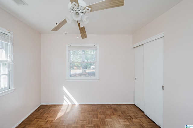 unfurnished bedroom featuring multiple windows, a closet, visible vents, and a ceiling fan