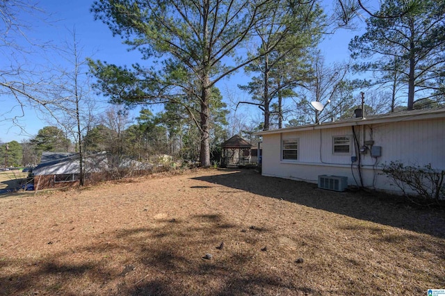 view of yard with central AC unit and a gazebo