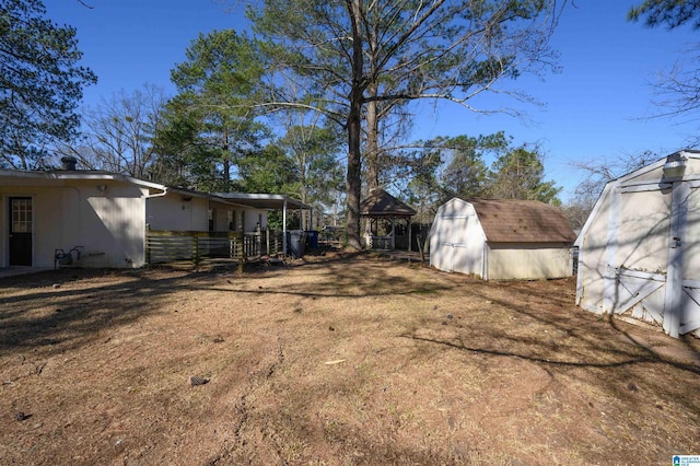 view of yard featuring a gazebo, a shed, and an outdoor structure