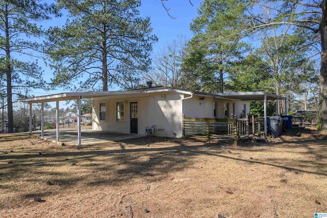 view of front of home with a carport and a front lawn