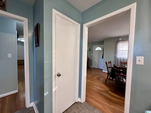 hall featuring baseboards and wood finished floors