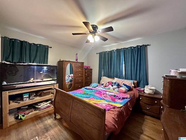 bedroom with a ceiling fan and wood finished floors